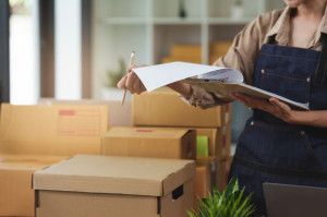 Close up Asian woman, e-commerce employee freelance with parcel box for deliver to customer. Online marketing packing box delivery concept.